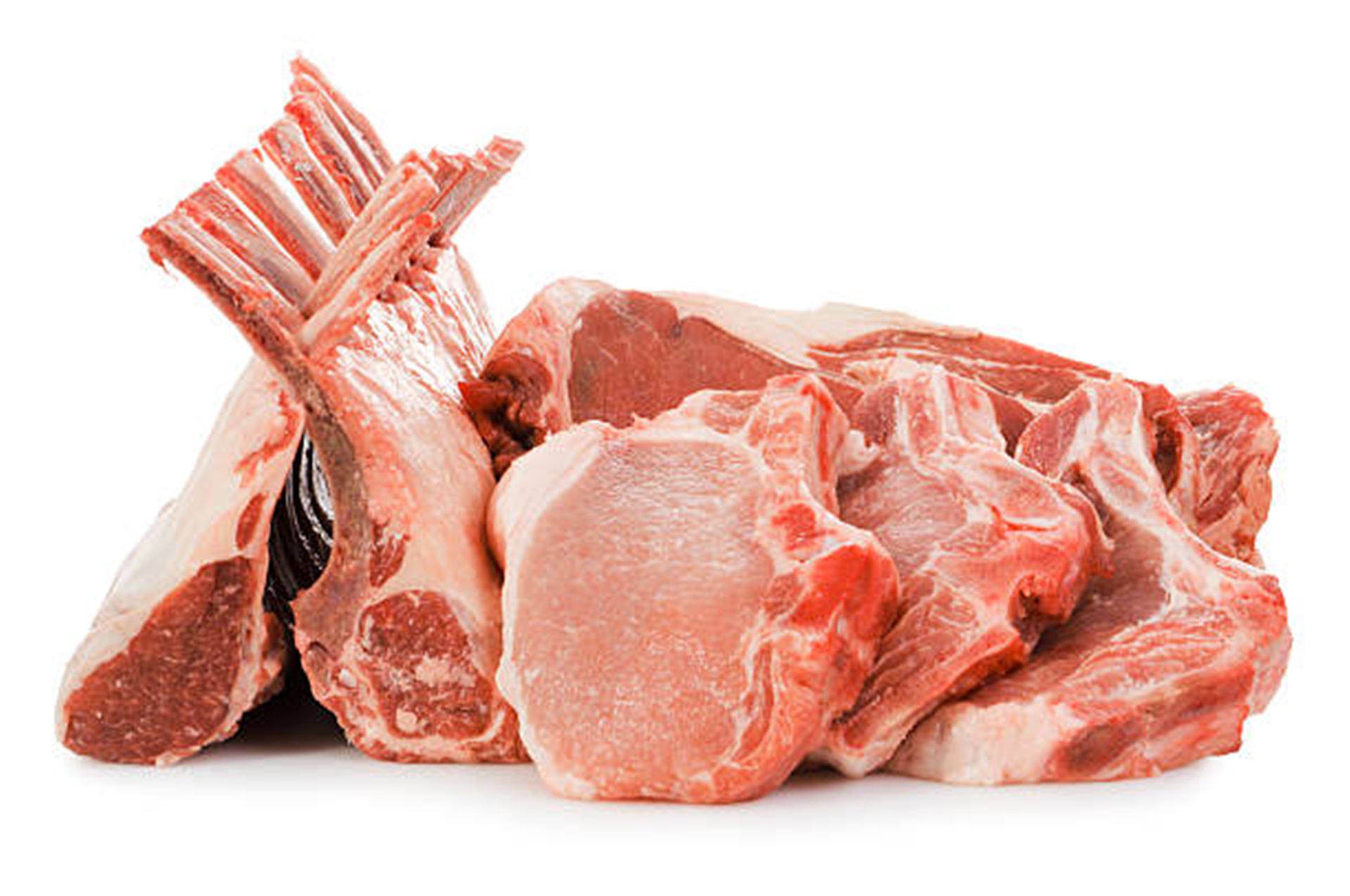 Subject: A variety of meat including rack of lambs, pork chops, and rib eye beef steaks, isolated on a white background.